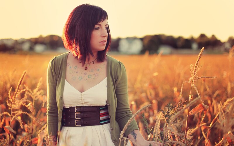 Woman in a field at sunset