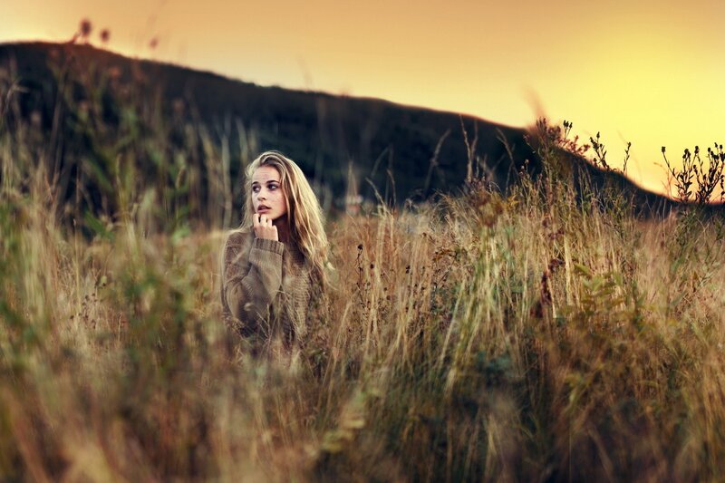 woman in a field at sunset