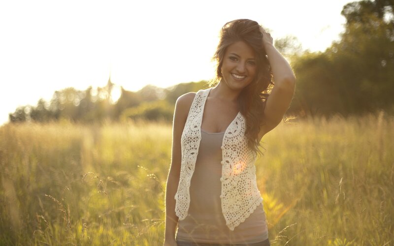 woman in a field at sunset
