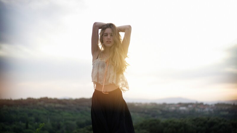 Woman in a field at sunset