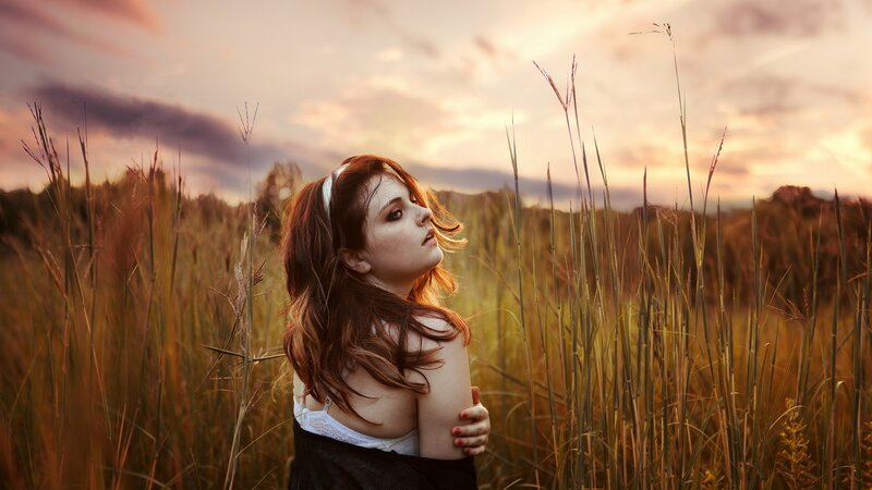 woman in a field at sunset