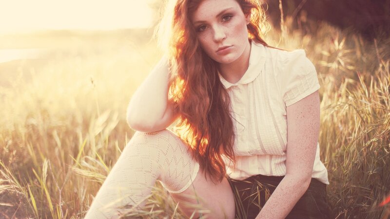 woman in a field at sunset