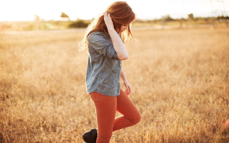 woman in a field at sunset