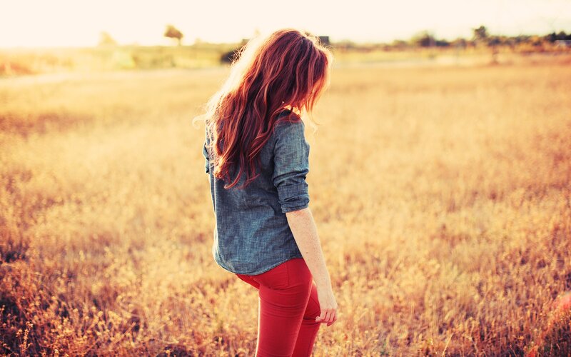 woman in a field at sunset