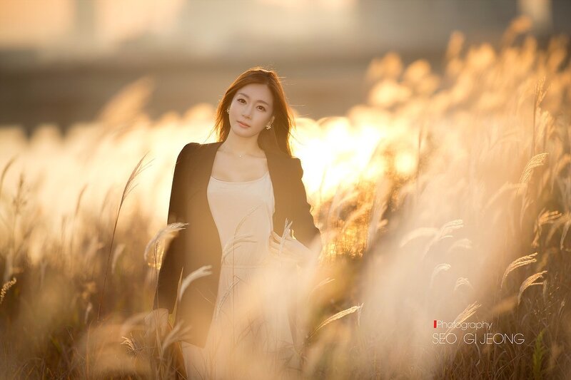 woman in a field at sunset