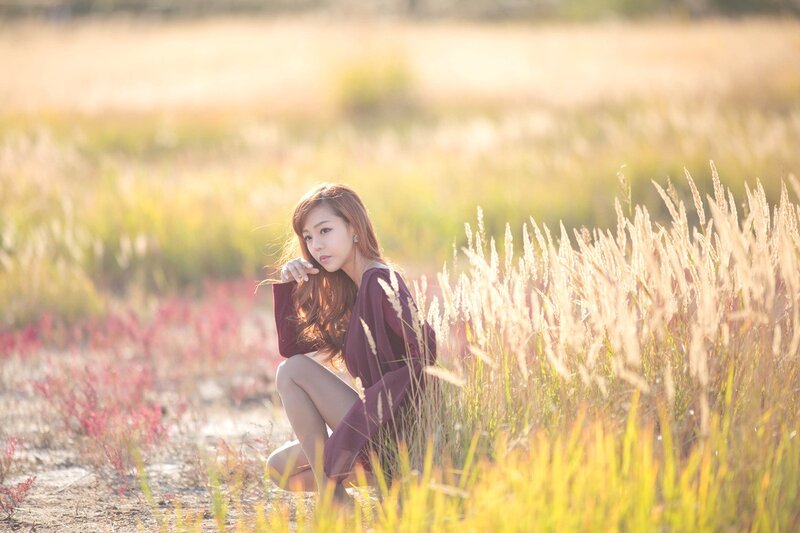 Woman in a field at sunset