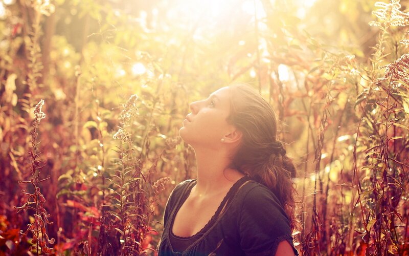 woman in a field at sunset