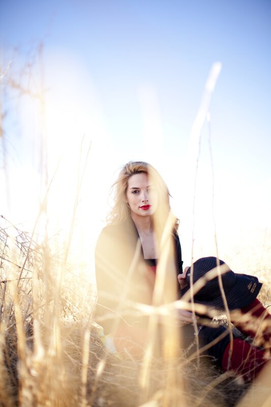 woman in a field at sunset