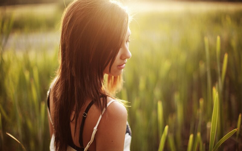 woman in a field at sunset