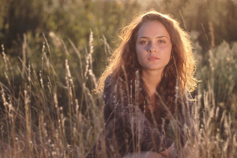 woman in a field at sunset