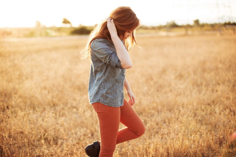 woman in a field at sunset
