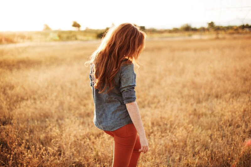 woman in a field at sunset