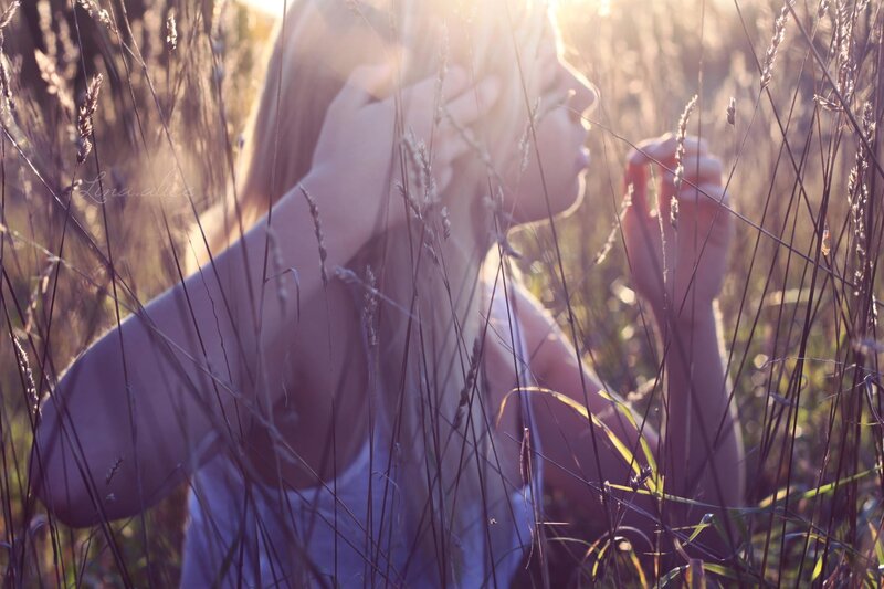 woman in a field at sunset