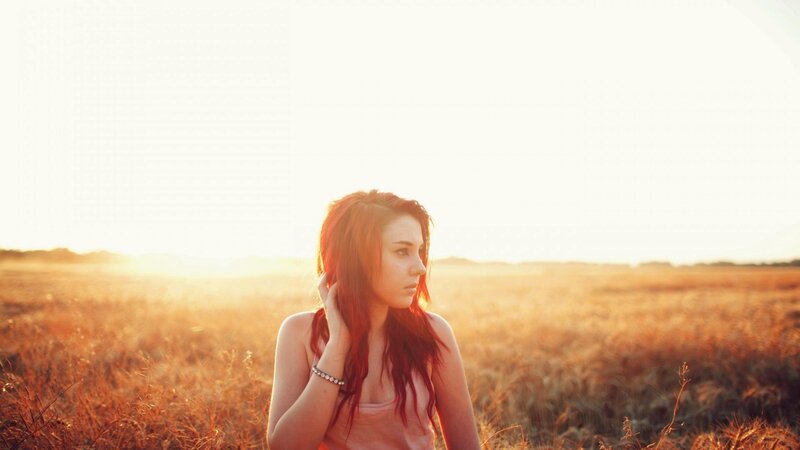 woman in a field at sunset