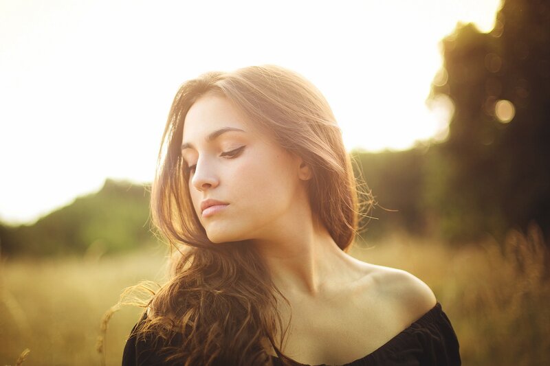 woman in a field at sunset