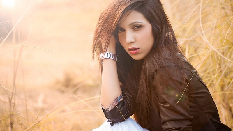 woman in a field at sunset