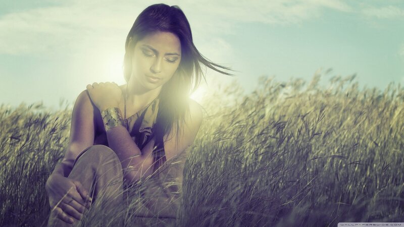 woman in a field at sunset
