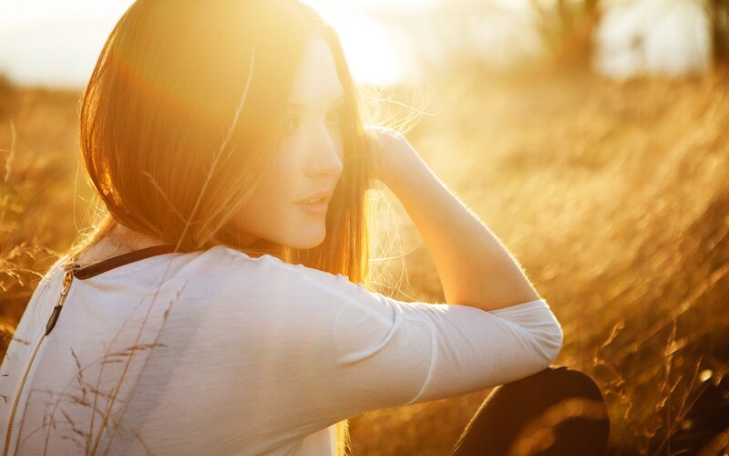 woman in a field at sunset