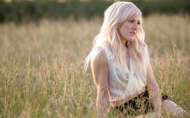 woman in a field at sunset