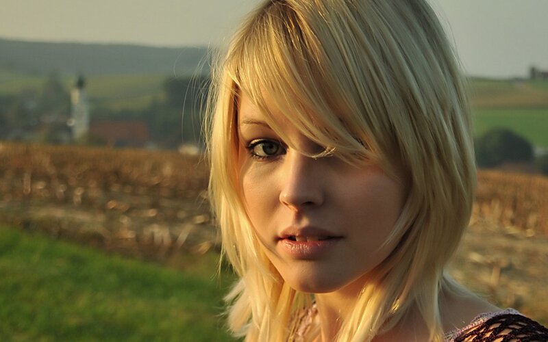 woman in a field at sunset