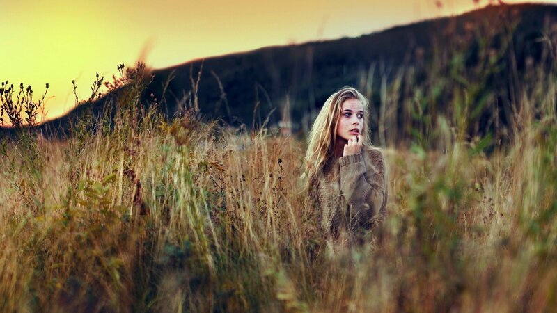 woman in a field at sunset