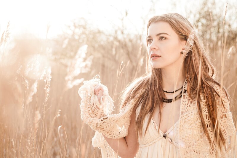 woman in a field at sunset