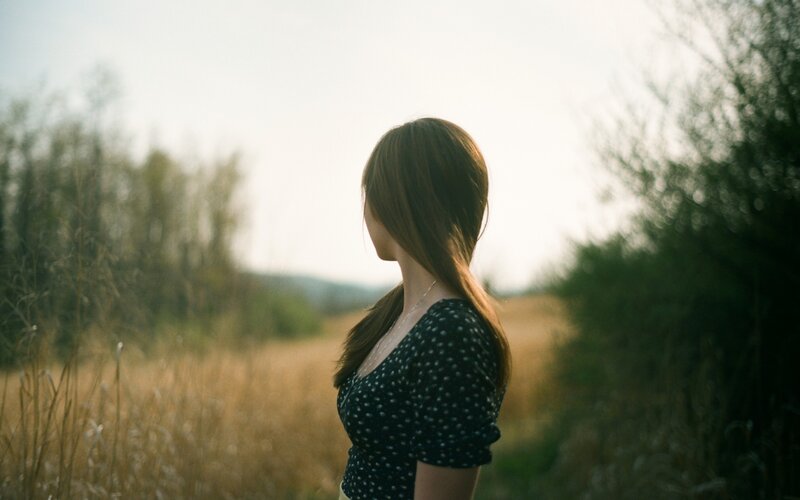 woman in a field at sunset