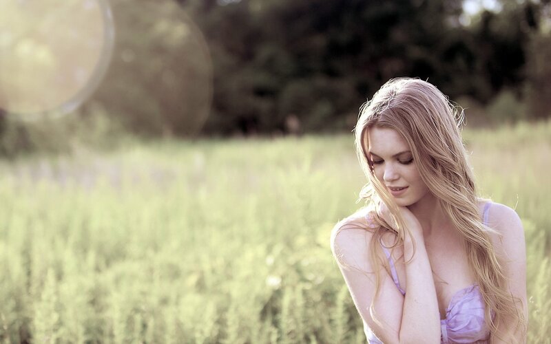 woman in a field at sunset