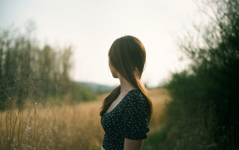 woman in a field at sunset