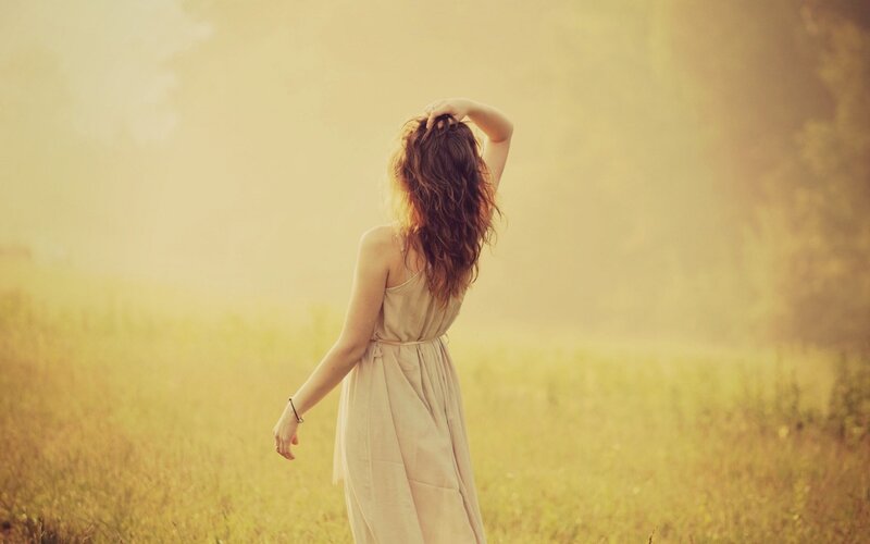 woman in a field at sunset