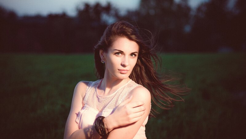 woman in a field at sunset