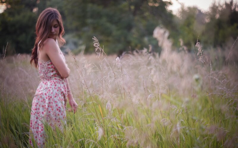 woman in a field at sunset