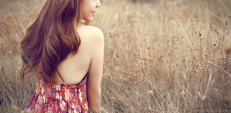 woman in a field of dry grass