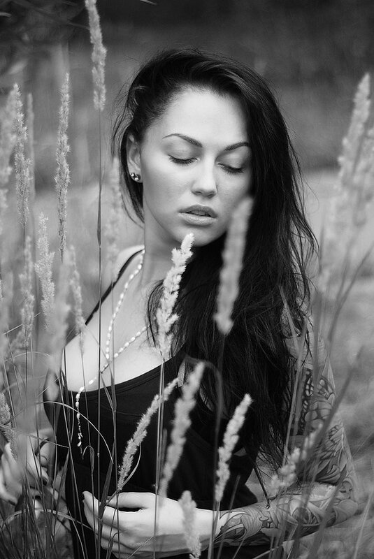 woman in a field of tall grass