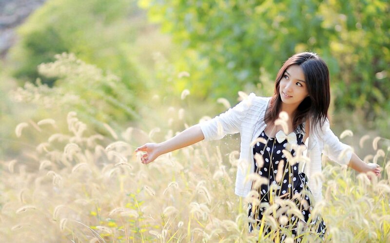 woman in a field of tall grass