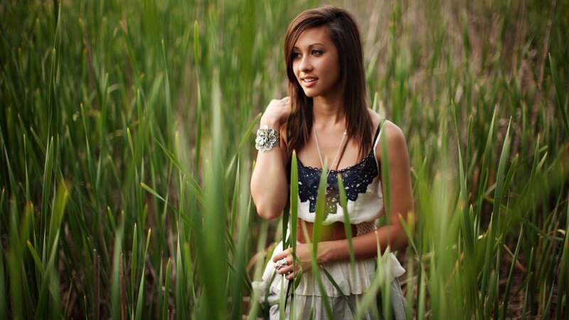 woman in a field of tall grass