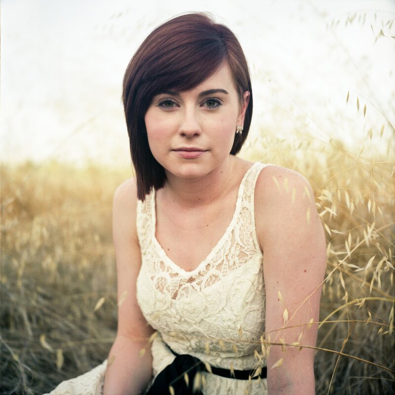 woman in a field of tall grass