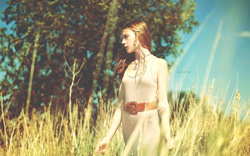 woman in a field of tall grass
