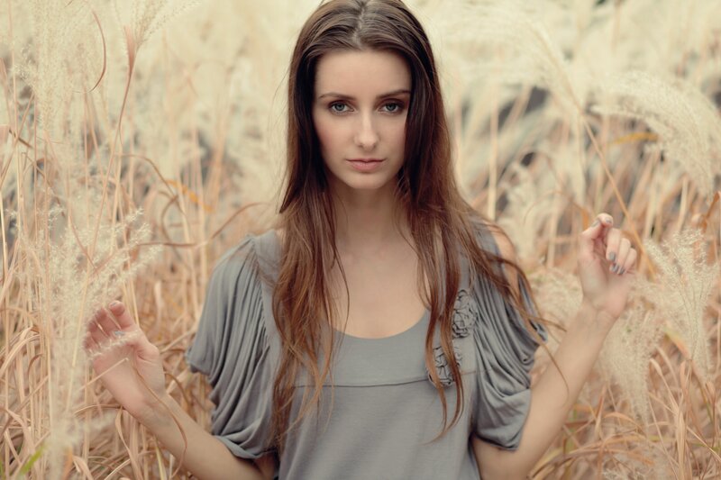 woman in a field of tall grass