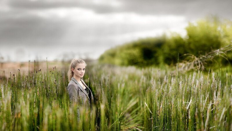 woman in a field of tall grass