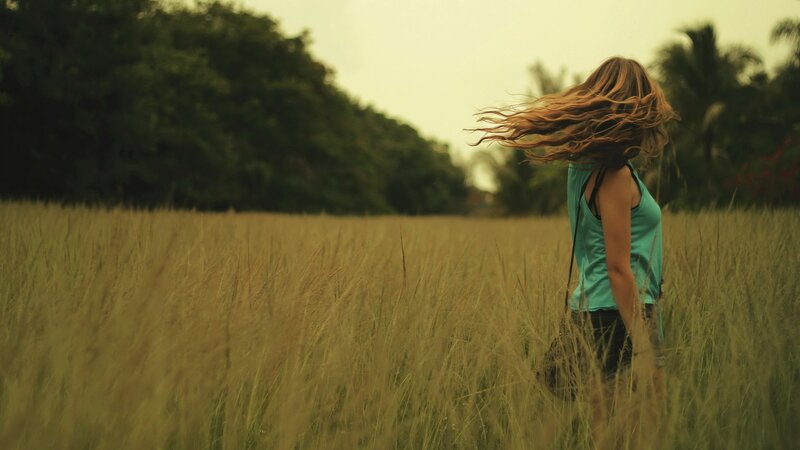 Woman in a field of tall grass