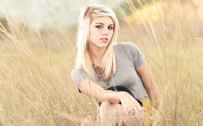 woman in a field of tall grass
