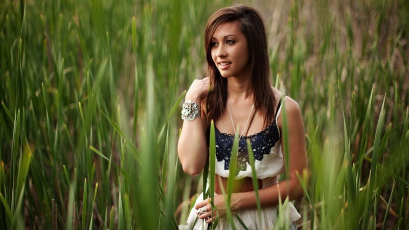 woman in a field of tall grass