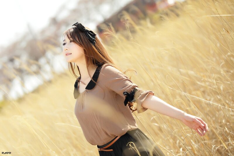 woman in a field of tall grass