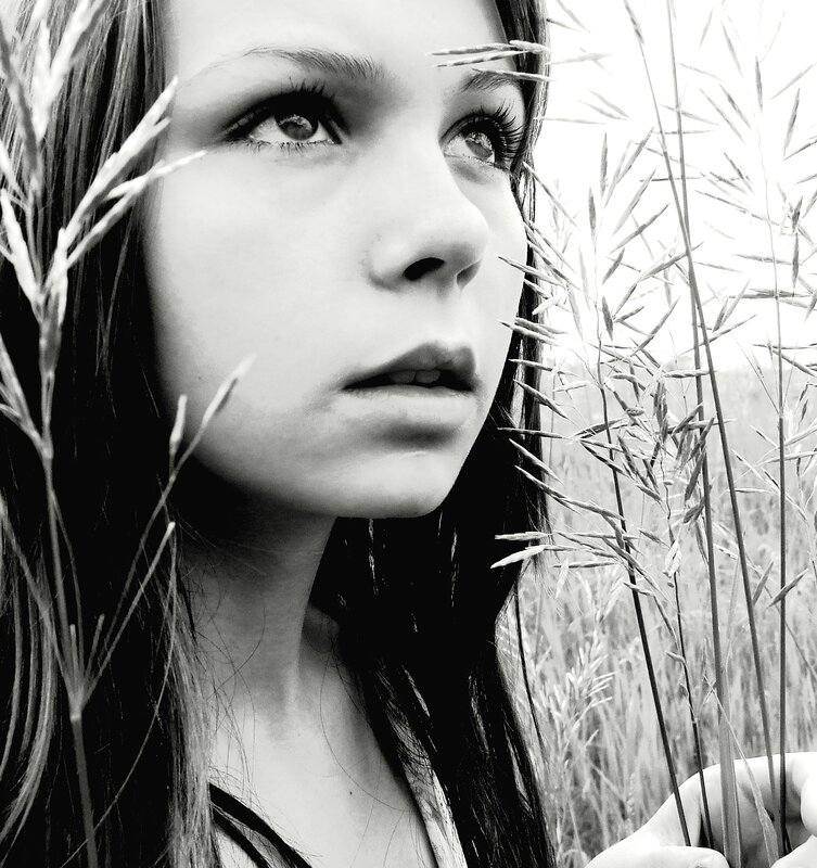 woman in a field of tall grass