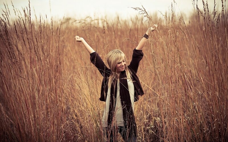 Woman in a field of tall grass