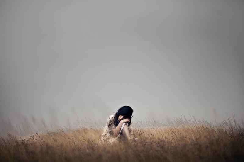 woman in a field of tall grass