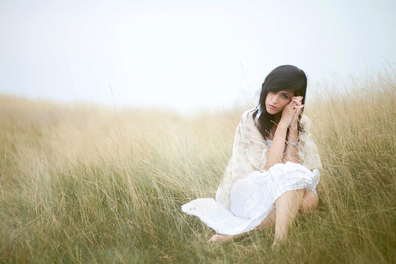 woman in a field of tall grass