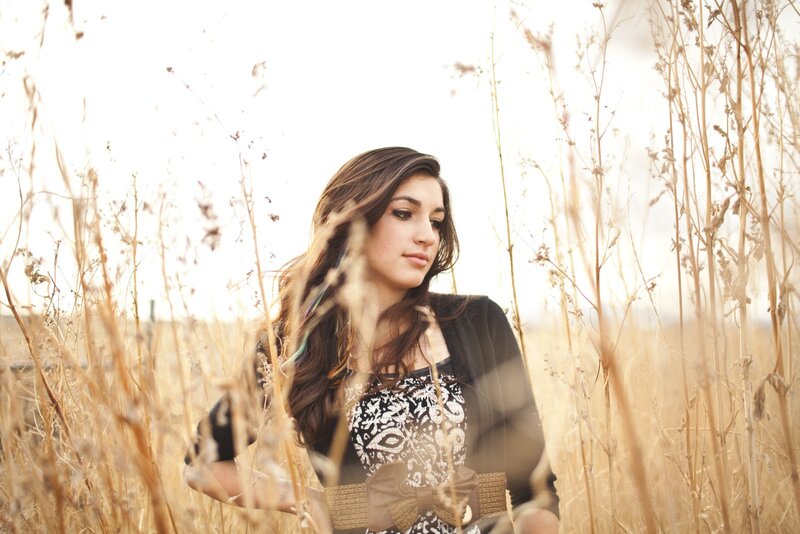 woman in a field of tall grass