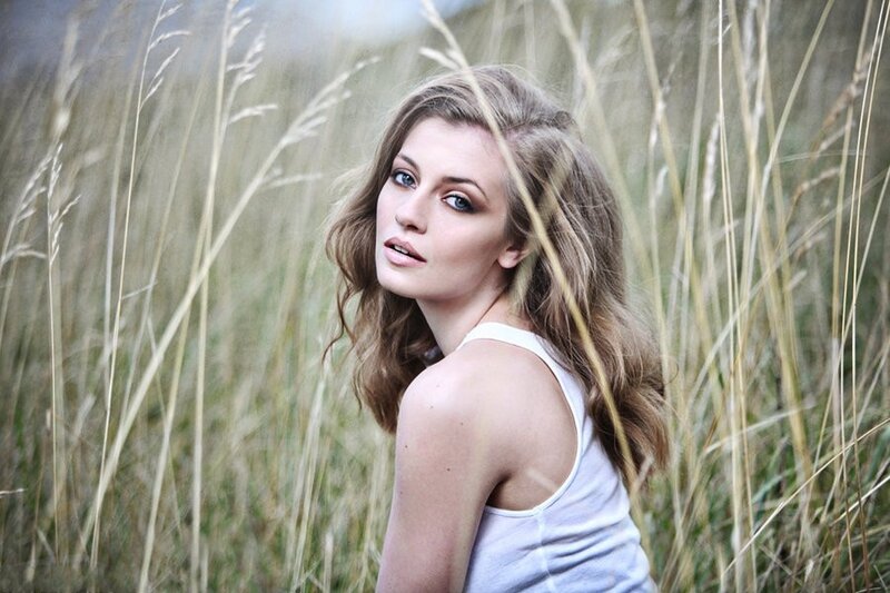 woman in a field of tall grass